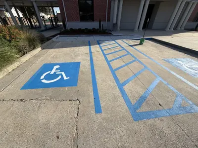 New blue ADA parking space and access aisle striping