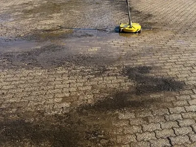 Pressure washing a dirty paver parking area with a surface cleaner