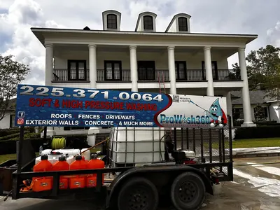 ProWash360 trailer parked in front of a large white two-story home